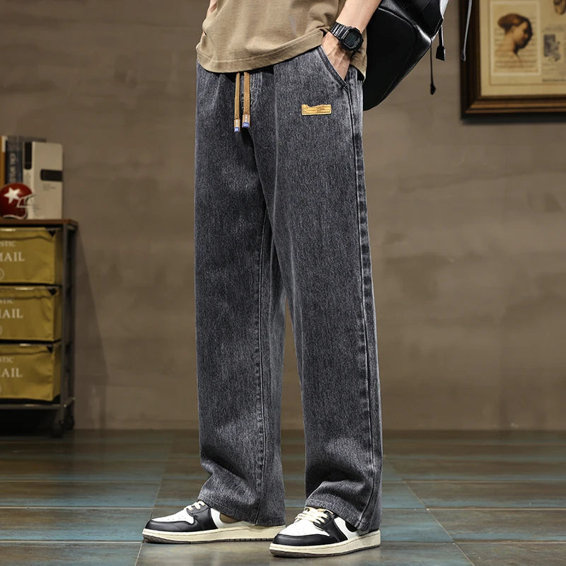 Relaxed fit men's denim joggers, wide leg, drawstring waist, ideal for casual and comfortable wear.