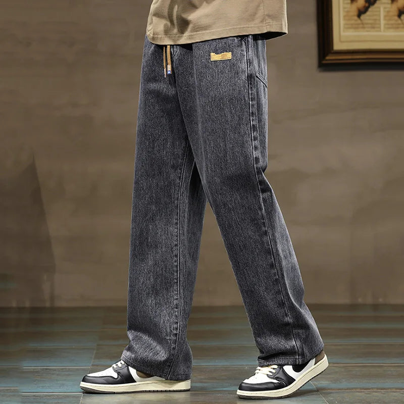 Denim style men's jogger pants, rogue design, featuring a comfortable wide leg and drawstring.