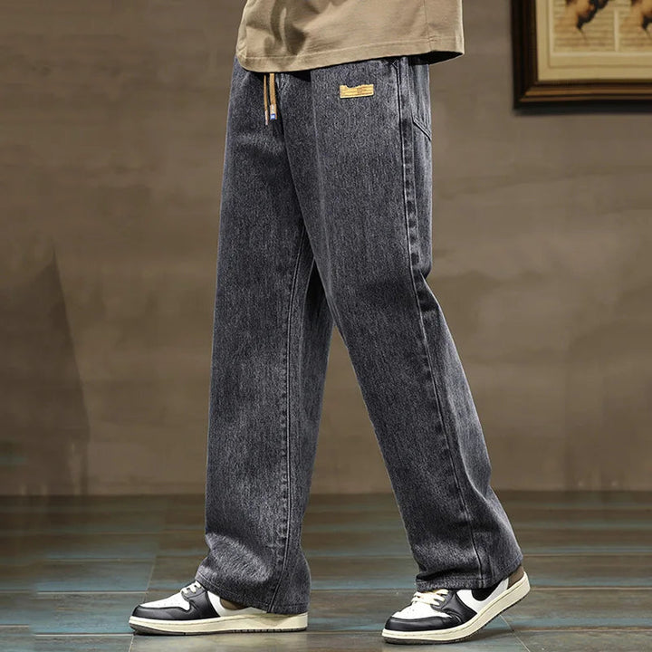 Denim style men's jogger pants, rogue design, featuring a comfortable wide leg and drawstring.