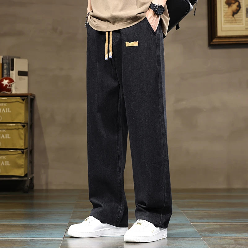 Ultimate comfort men's casual pants: wide-leg denim joggers with relaxed fit and drawstring waist.