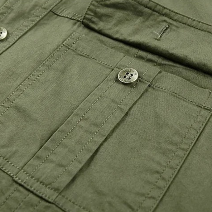 Man wearing a rugged cotton short sleeve shirt, showcasing its casual and comfortable fit for outdoor use.