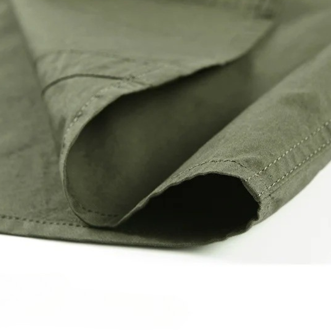 Front view of a men's rugged cotton short sleeve shirt, featuring a classic design for casual and utility style.