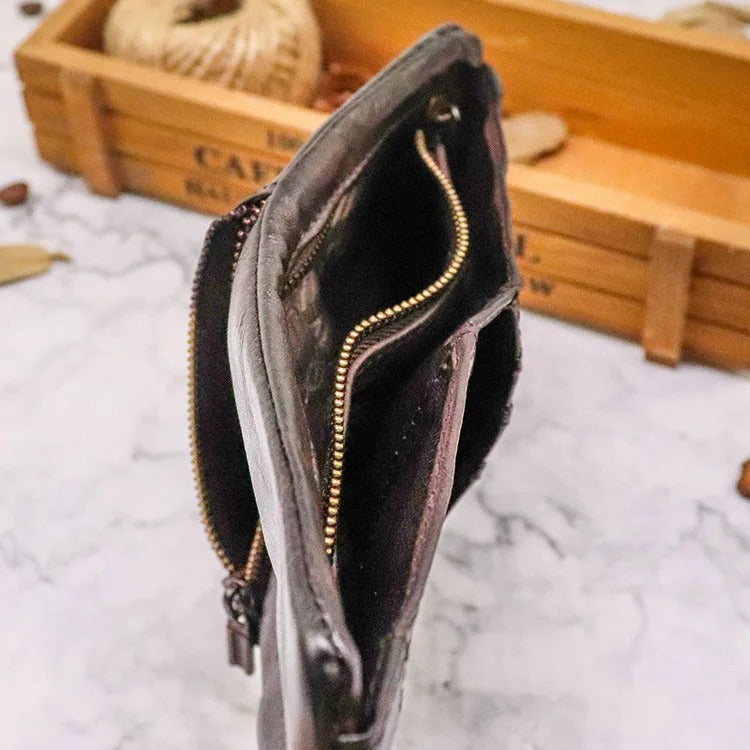 Men's everyday carry bifold wallet made from distressed leather, featuring a snap closure.