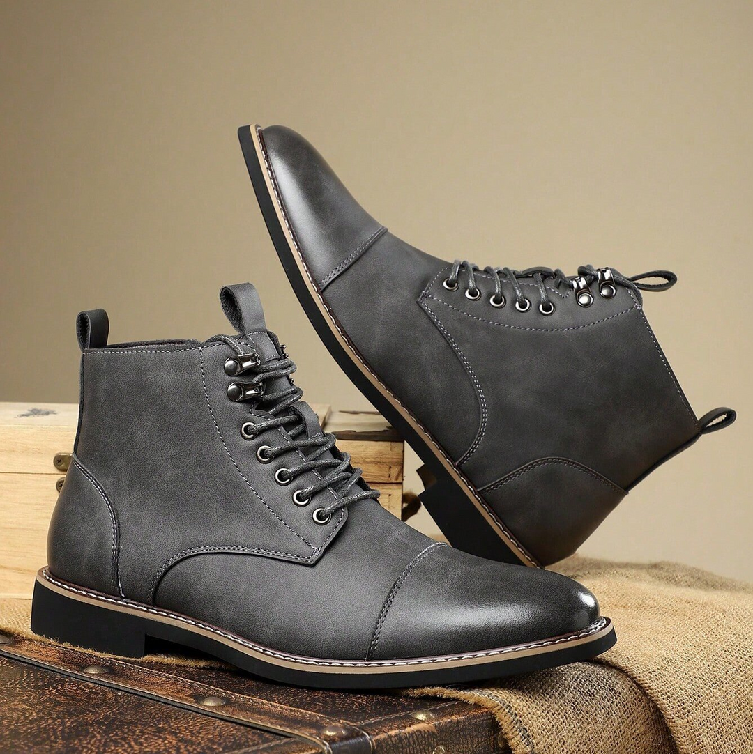 Close-up of men's rugged boots with strong laces & durable soles, ideal for all terrains.