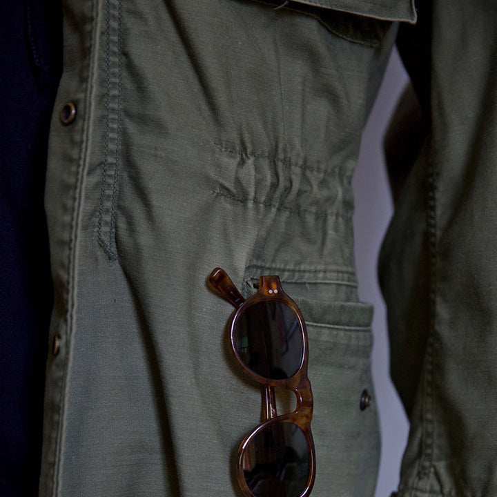 Versatile men's green hooded field jacket for outdoor adventures. Rugged utility style with storm protection.