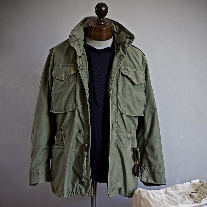 Black men's rugged field jacket with an adjustable hood, ideal for outdoor activities & casual outerwear.