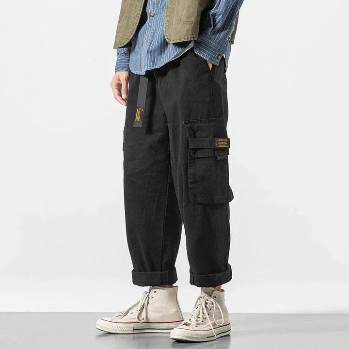 Stylish men's cargo pants, rugged utility aesthetic, relaxed fit cotton for a casual streetwear look.