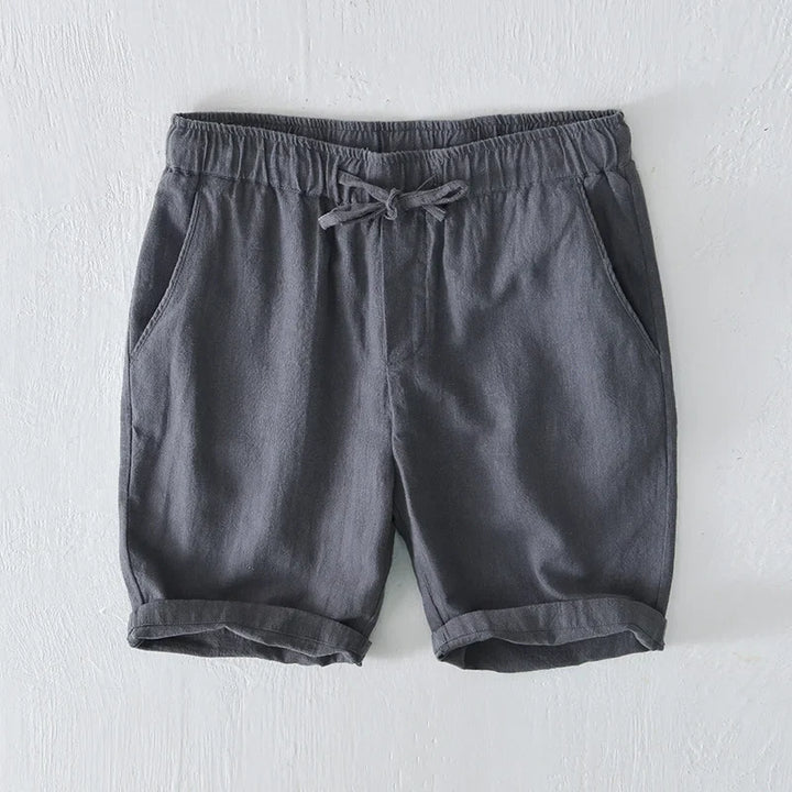 Man in men's Santorini shorts, enjoying vacation. Perfect relaxed fit beachwear.