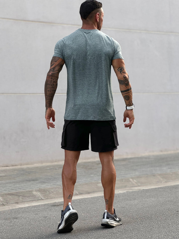 Man running in a Blue Men's Sevilla Performance Tee. Sportswear for athletic performance.