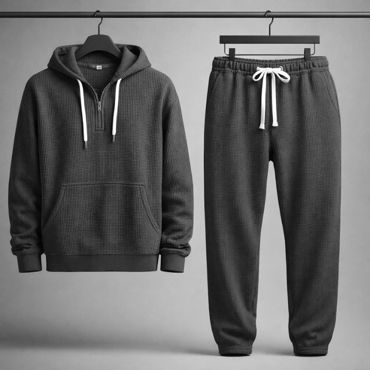 Modern Men's Leisure Waffle Knit Set. Grey apparel with quarter-zip hoodie & joggers, designed for comfort & style.