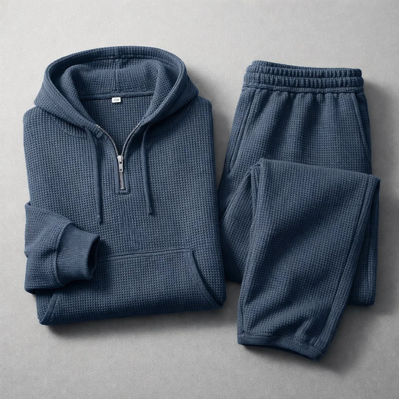 Men's Quarter-Zip Waffle Knit Top. Detail of the grey hoodie's zipper and texture, part of a comfort set.