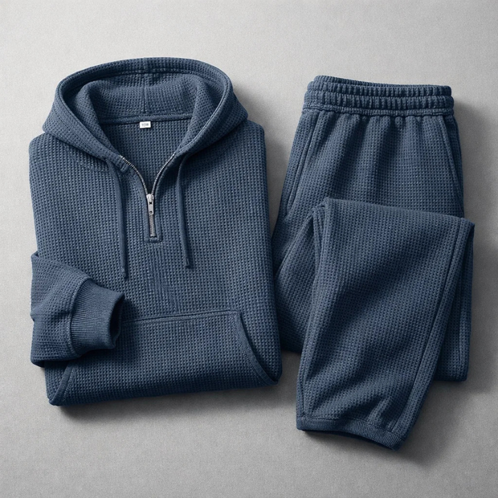 Men's Quarter-Zip Waffle Knit Top. Detail of the grey hoodie's zipper and texture, part of a comfort set.