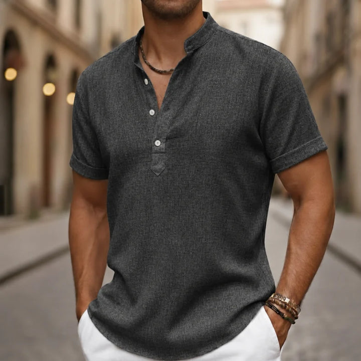 Man wearing a comfortable, relaxed fit men's short sleeve Henley polo shirt for summer. Casual look.