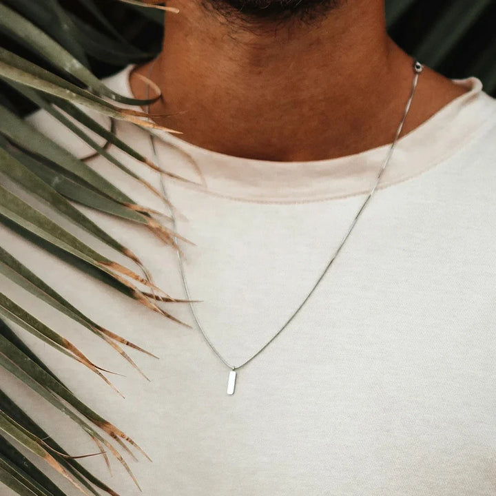 Modern men's sleek bar pendant necklace, crafted from durable stainless steel. Minimalist design for him.