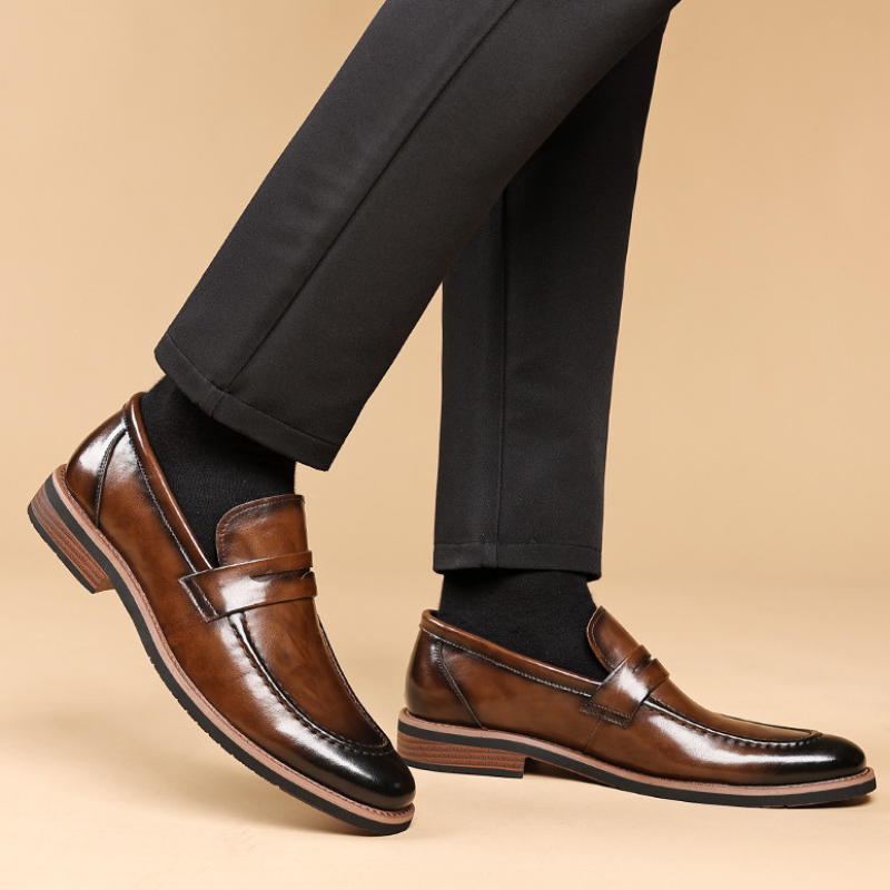 Durable men's leather penny loafers, timeless design in brown, offering comfort and sleek style for any occasion.