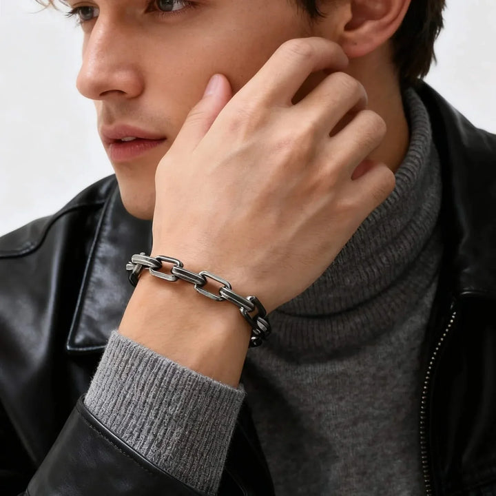 Stylish men's chain link bracelet on wrist, a sleek, non-tarnishing accessory that elevates any modern look.