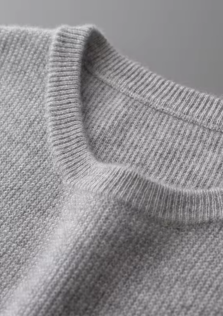 Beige men's crew neck vest, ideal for layering. This minimalist sleeveless top offers all-season casual style.