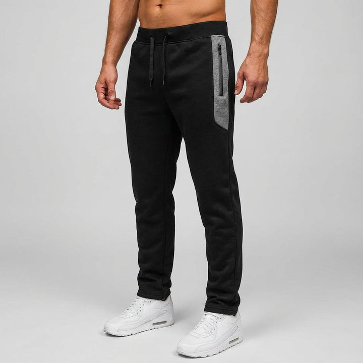 Sporty men's jogger pants in slim fit, featuring practical leg zippers, ideal for casual wear