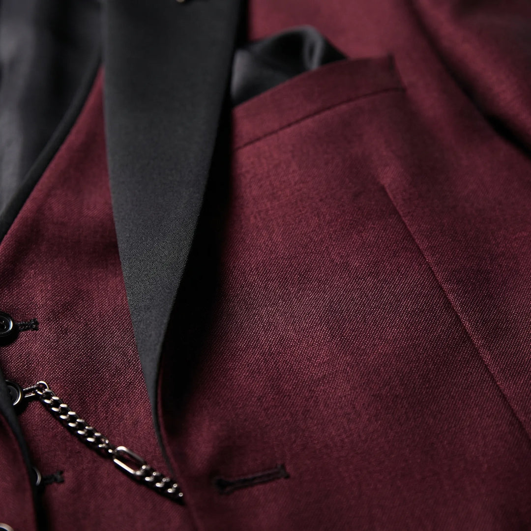 Tailored slim-fit burgundy 3-piece men's suit with contrast lapel, ideal for modern formal wear.