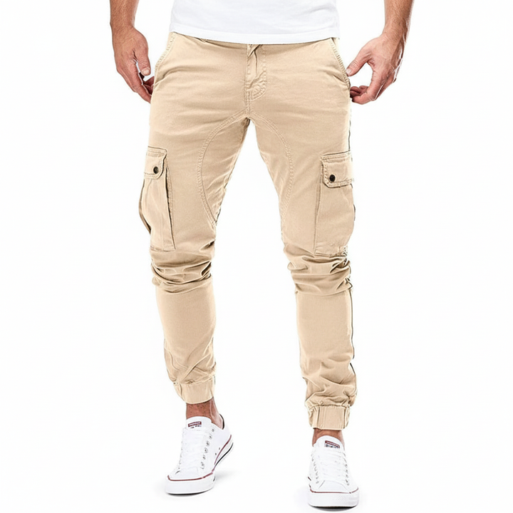 Close-up of men's slim fit cargo pants showing side utility pockets and fabric detail.