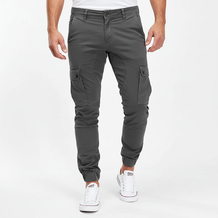 Man wearing slim fit cargo pants, Andreas design, demonstrating comfortable fit and movement.