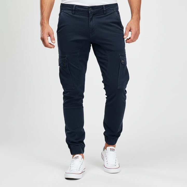 Detail of a cargo pocket on men's slim fit pants, highlighting secure button closure.