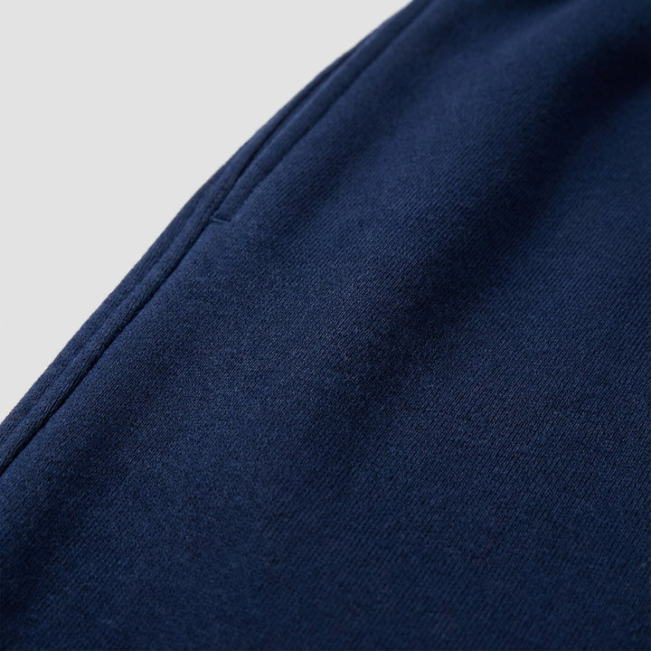 Close-up of men's slim fit joggers fabric, showing soft cotton blend texture & ankle cuff detail