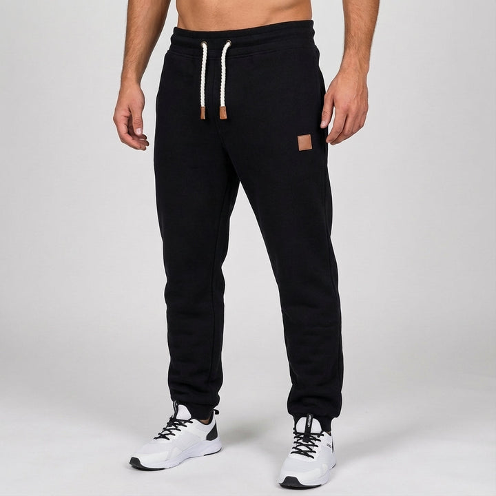 Detailed view of men's slim fit jogging bottoms pocket and sleek silhouette, essential activewear