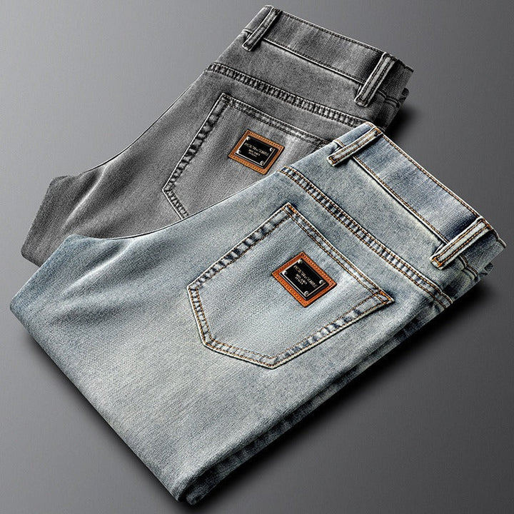 Gray slim fit stretch denim jeans for men, offering a modern and comfortable casual pant option.