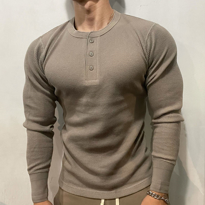 Comfortable men's henley muscle shirt, perfect for layering or everyday casual wear.