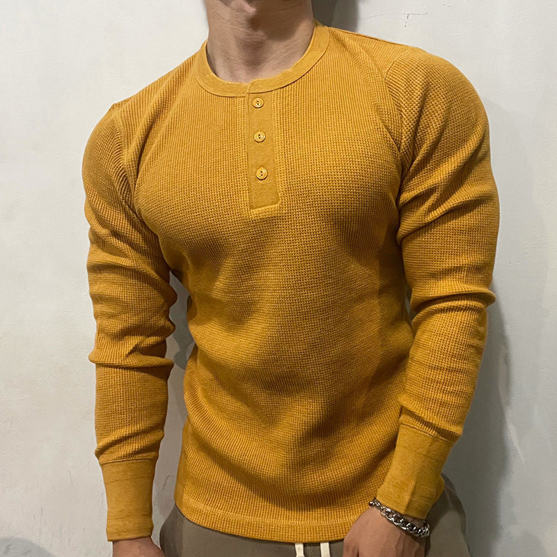 Casual men's henley muscle shirt, a comfortable layering top for versatile everyday wear.