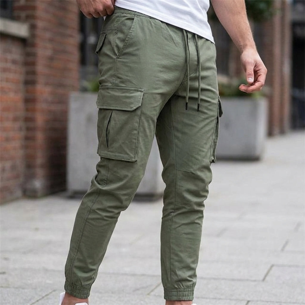 Men's slim fit jogger trousers in grey, breathable fabric with elastic waist and tapered leg