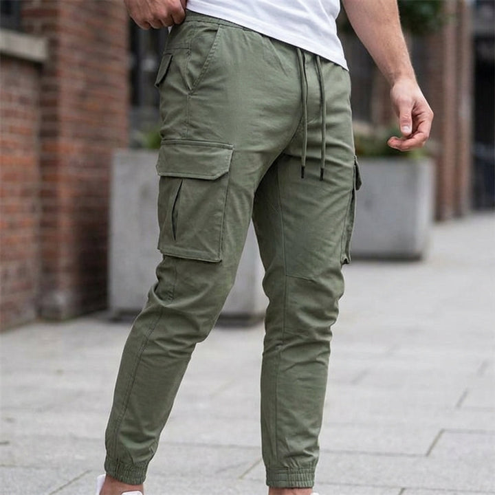 Men's slim fit jogger trousers in grey, breathable fabric with elastic waist and tapered leg
