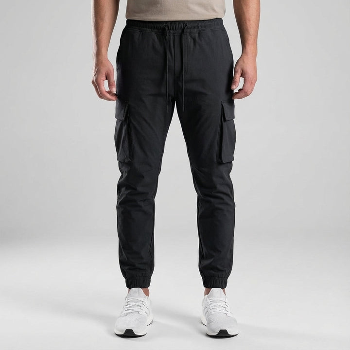 Men's slim fit joggers from the front, featuring elastic waist and functional utility pockets