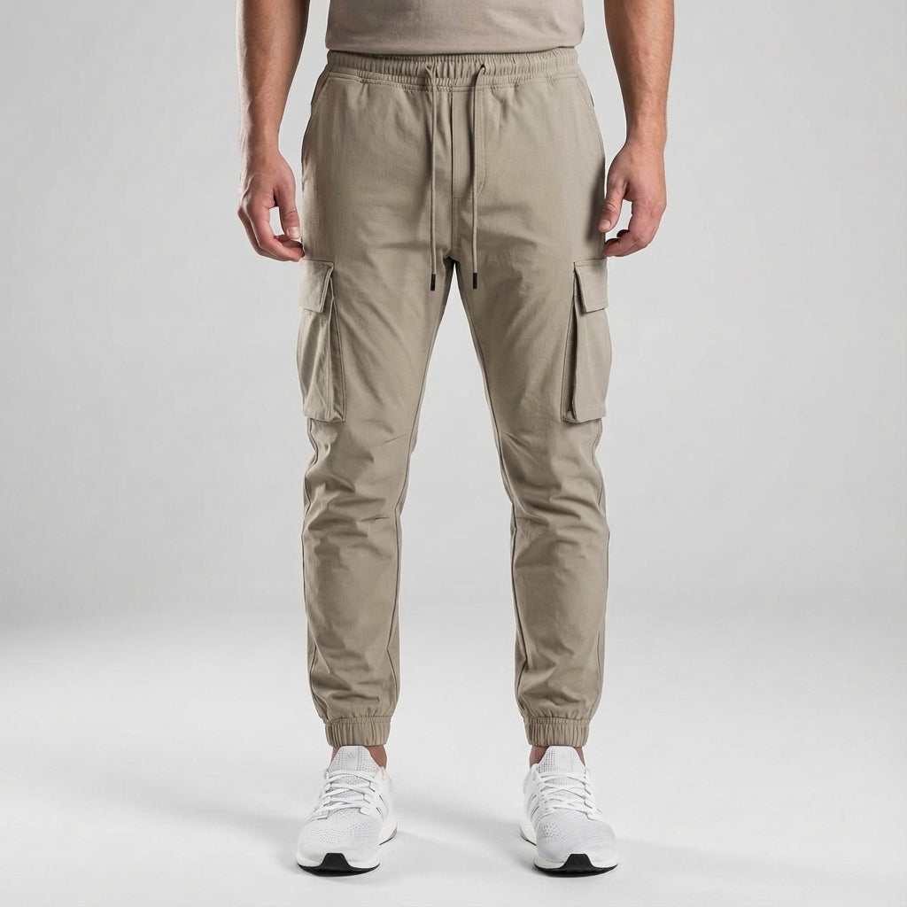 Model wearing men's slim fit jogger trousers, demonstrating a modern and athletic silhouette