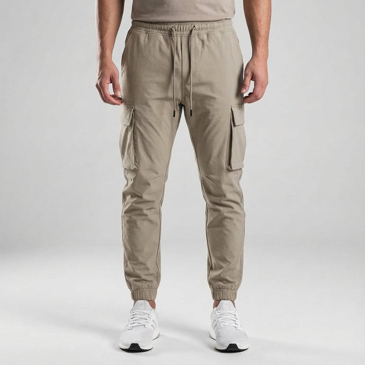 Model wearing men's slim fit jogger trousers, demonstrating a modern and athletic silhouette