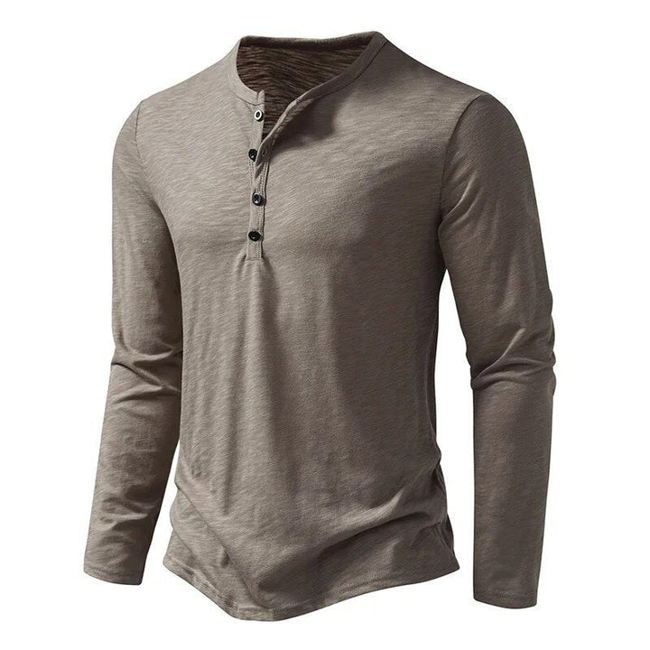 Comfortable black men's Henley shirt with a button placket, ideal for versatile everyday wear.