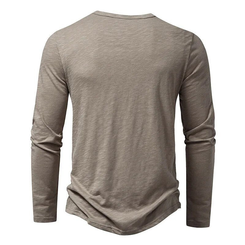 Stylish navy blue slim fit long sleeve Henley, a modern menswear wardrobe essential.