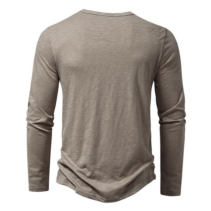 Stylish navy blue slim fit long sleeve Henley, a modern menswear wardrobe essential.