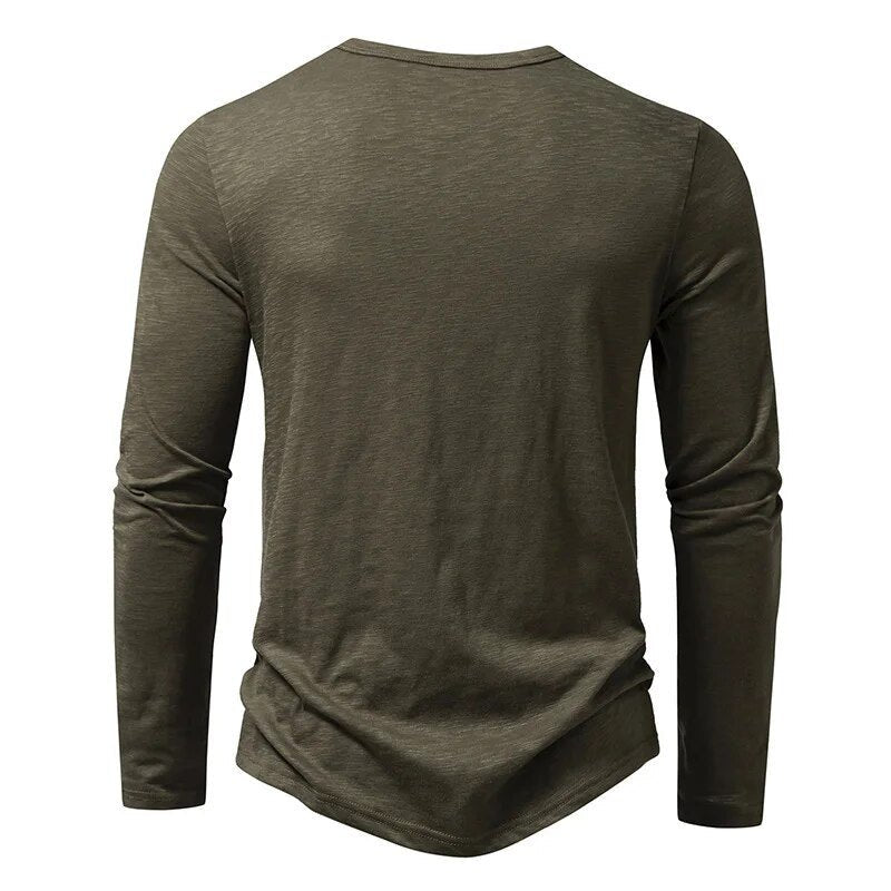 Man wearing a green slim fit Henley, showcasing its comfortable and modern casual look.