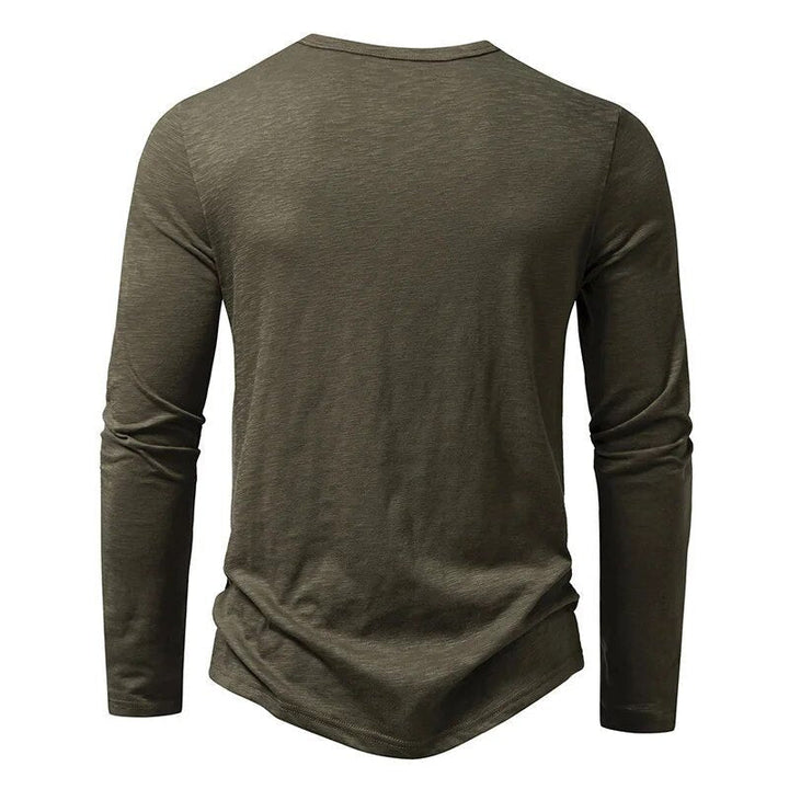Man wearing a green slim fit Henley, showcasing its comfortable and modern casual look.