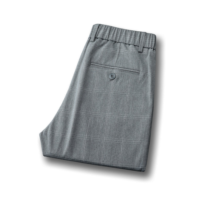 Details of men's tailored plaid pants, featuring a smart slim fit cut.