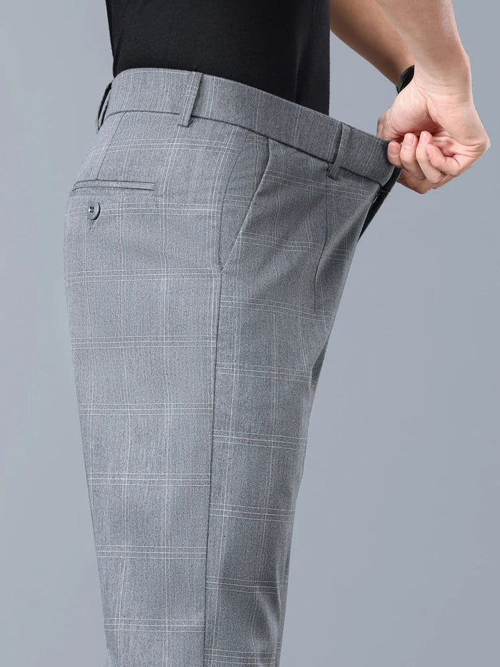 Close-up of the elegant plaid pattern on men's tailored slim fit dress pants.
