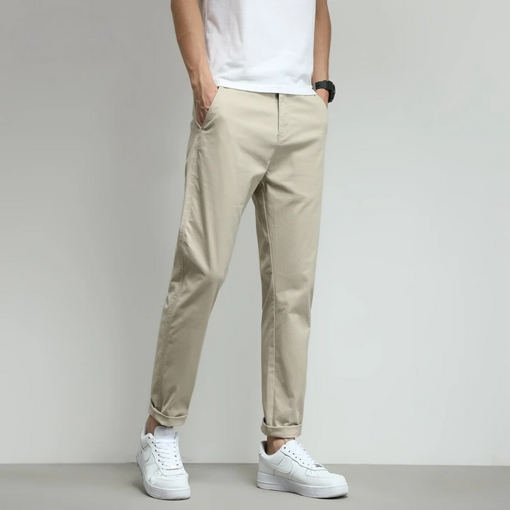 Beige slim-fit stretch tech travel trousers for men. Durable, breathable, & versatile.