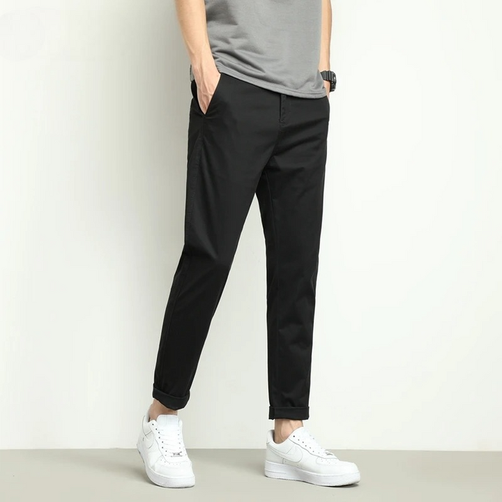 Durable men's slim-fit stretch travel trousers. Featuring water-resistant tech fabric in black.
