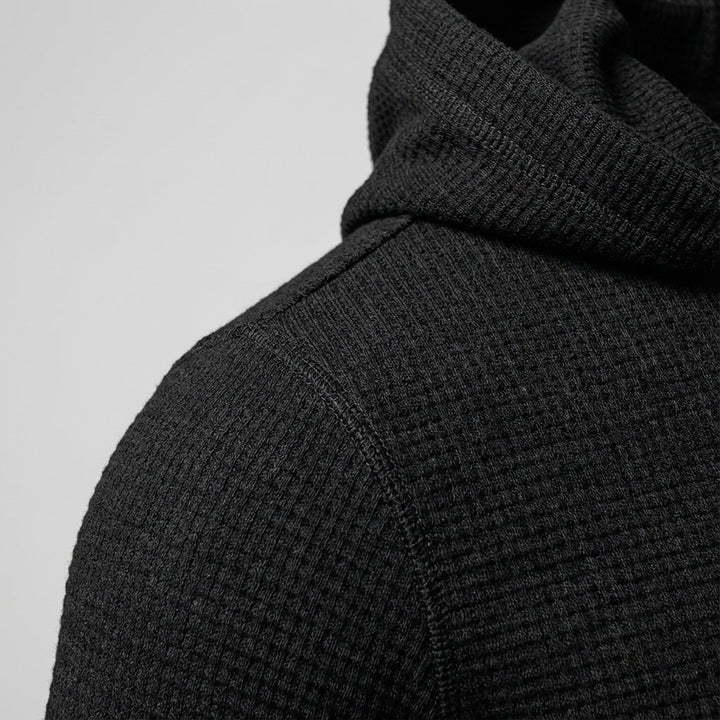 Close-up of the textured fabric on a men's training hoodie, perfect for gym attire.