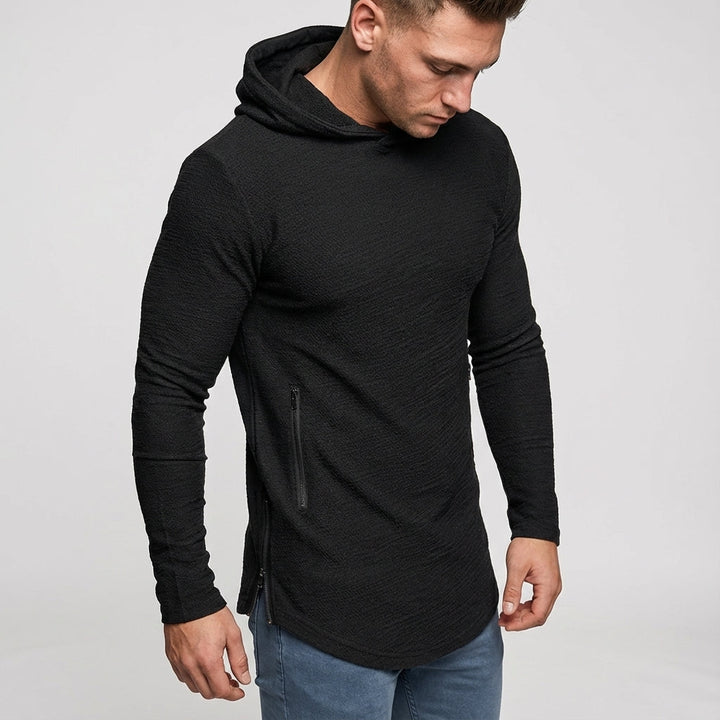 Male model wearing a gray slim fit training hoodie, showcasing its activewear design.