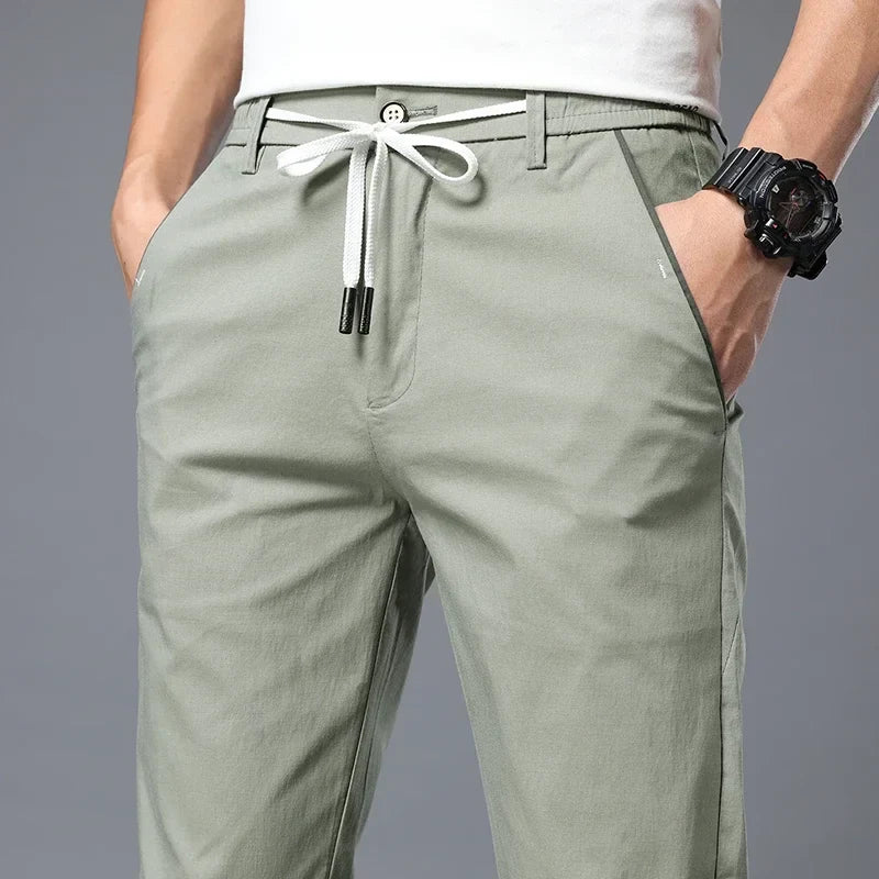 Men's slim fit versatile pants for everyday comfort & style. Wrinkle resistant with drawstring waist.