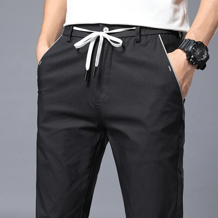 Comfortable men's versatile slim fit pants with drawstring waist, wrinkle-resistant for daily wear.