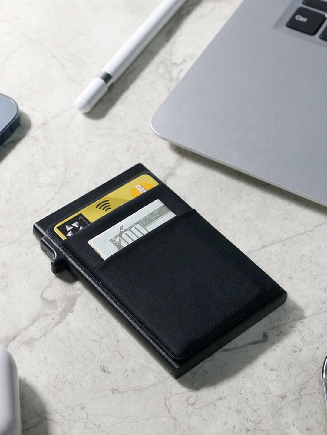 Detail of the smooth finish on a men's metal RFID blocking card holder, minimalist style